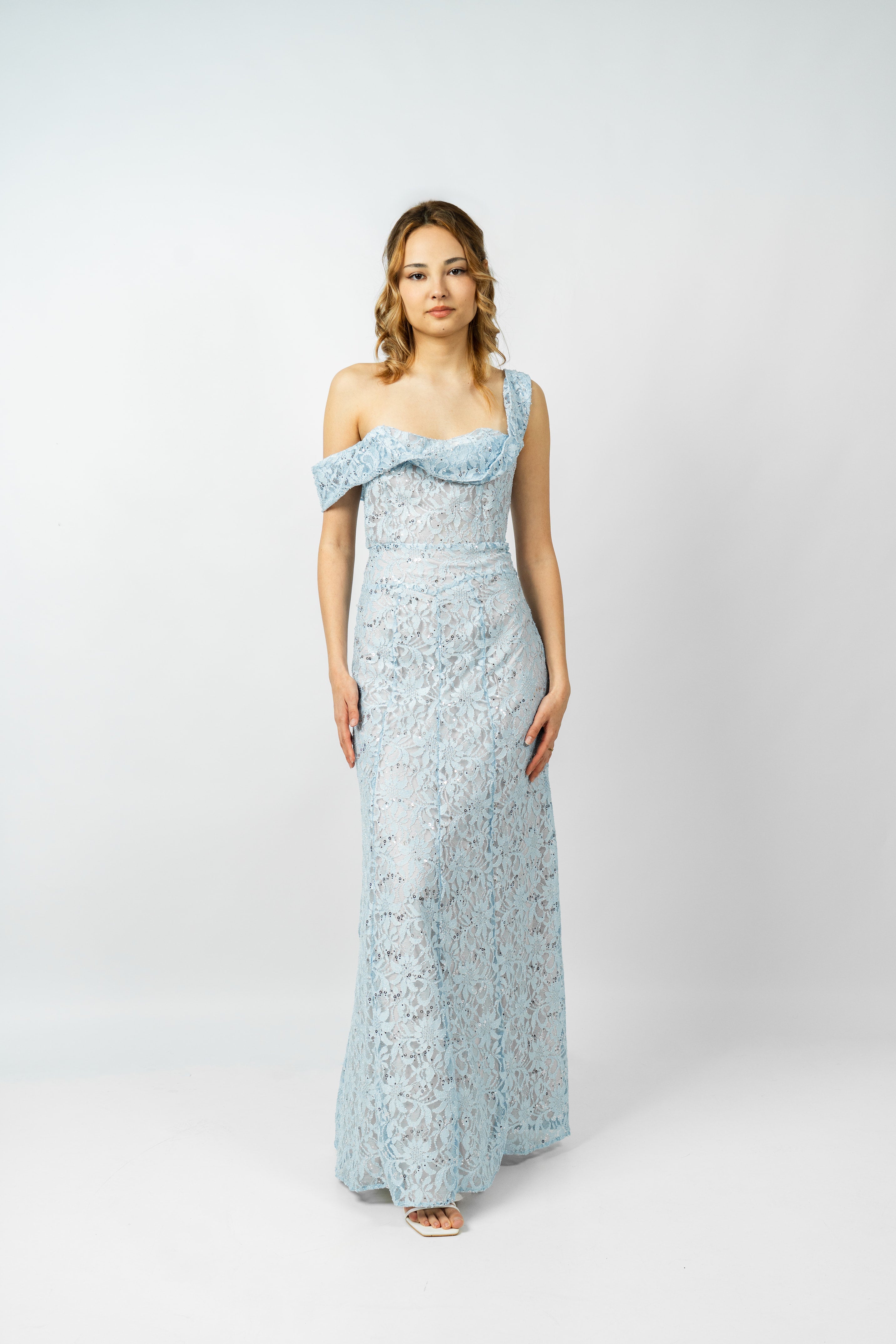 Woman wearing a light blue floral dress on a white background
