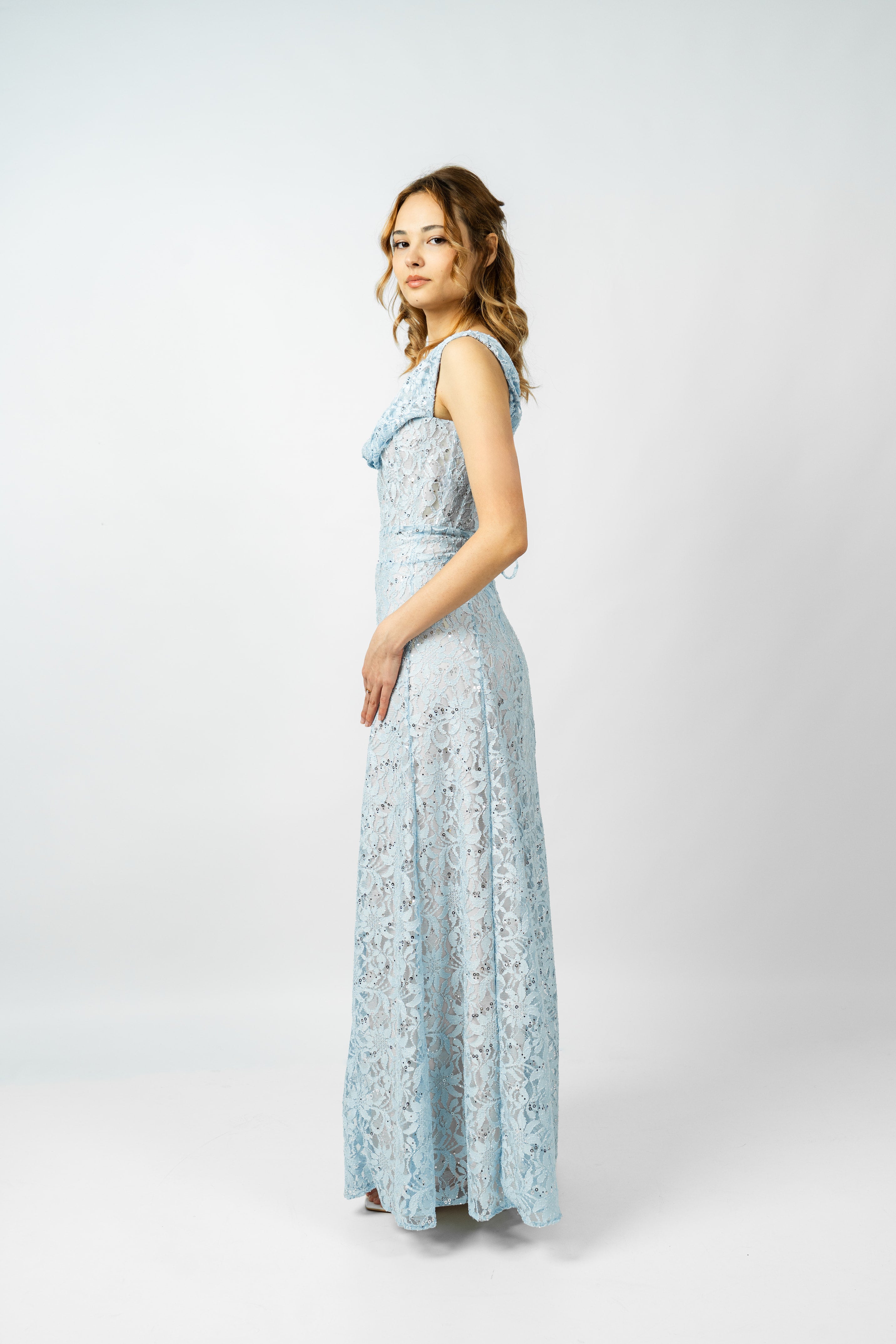 Woman wearing a light blue floral dress on a white background